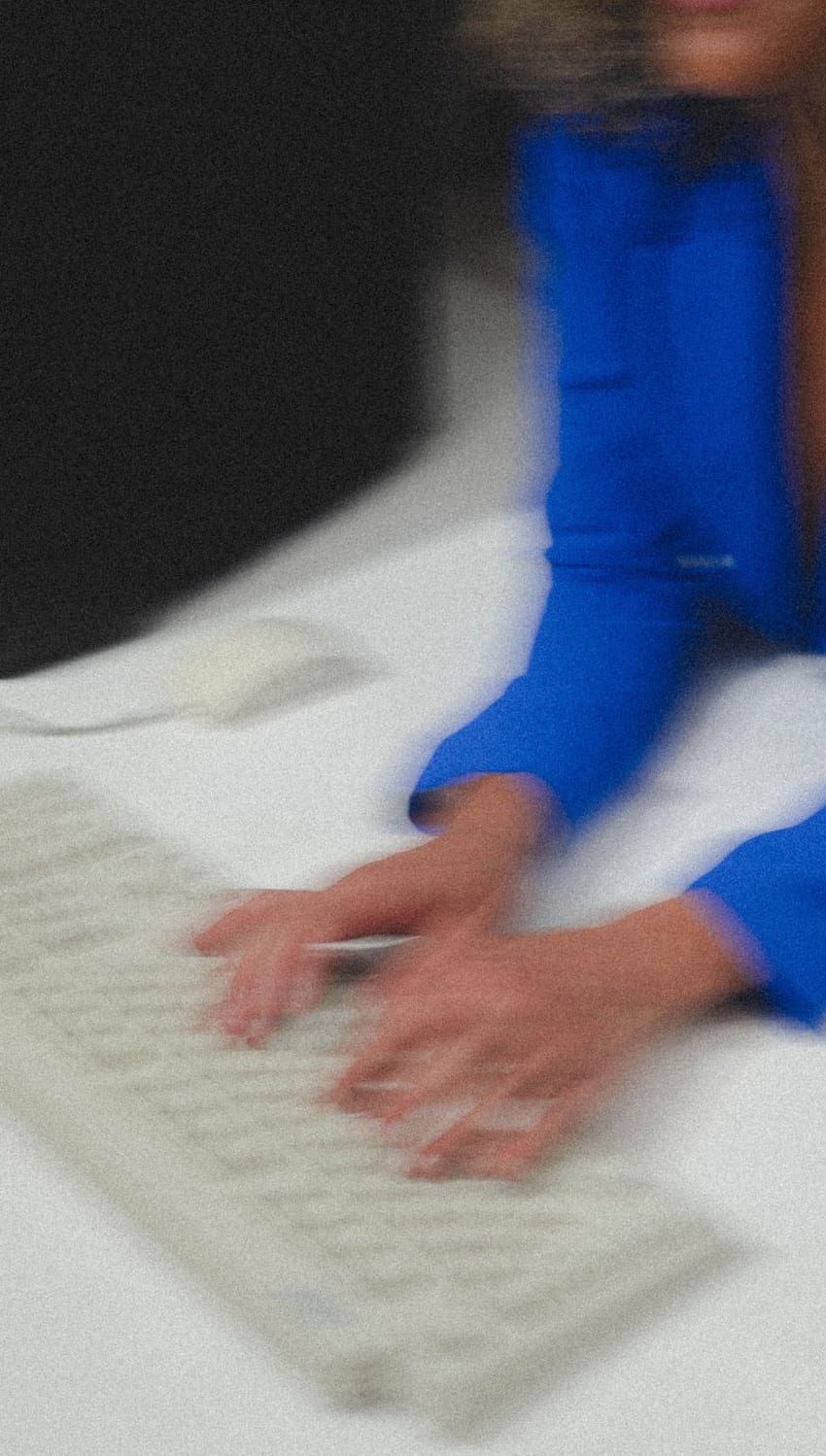 Hands typing quickly on a keyboard, motion blurred